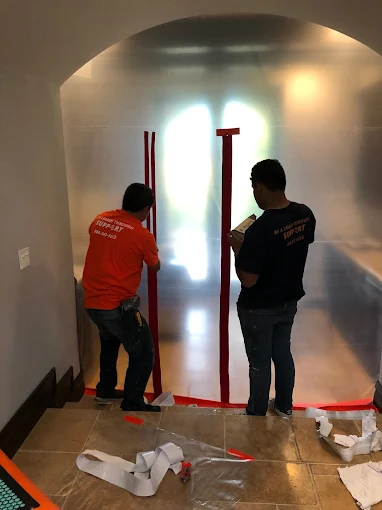 C&A Roofing mold remediation technicians in protective gear performing professional mold removal