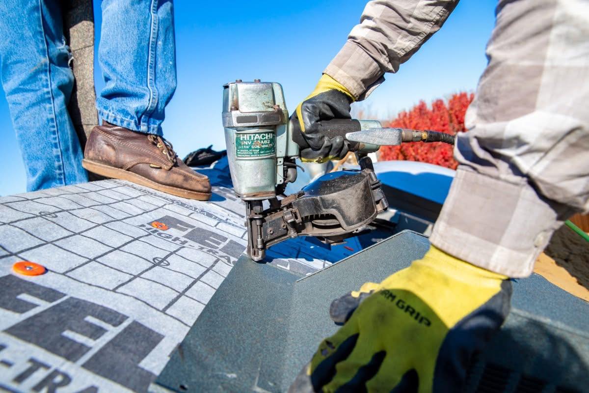 Ada roofing contractor installing shingles