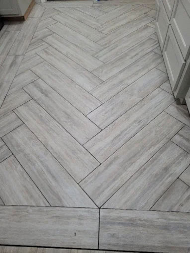 Herringbone pattern tile flooring installation