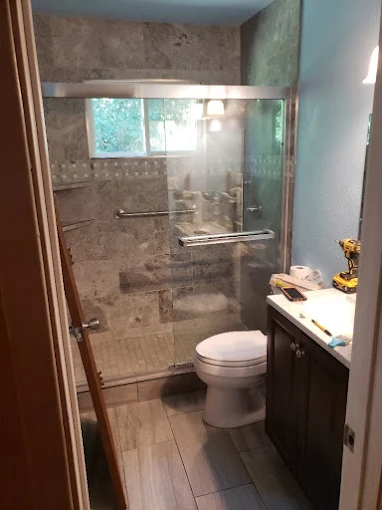 Complete bathroom renovation showcasing custom shower integration with modern fixtures and seamless design flow