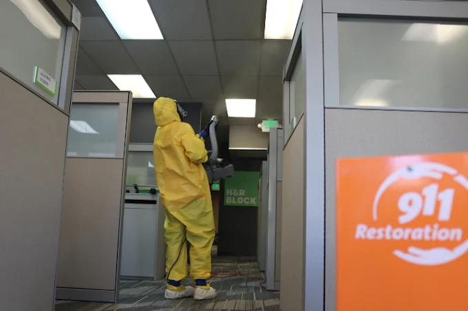 Professional mold remediation technician in hazmat suit performing commercial mold cleanup