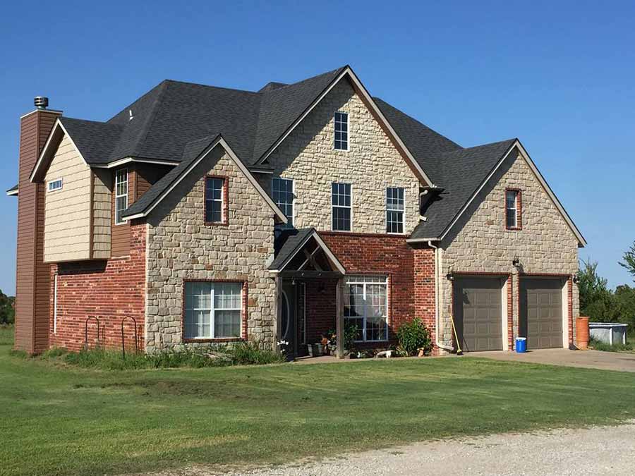Luxury stone and brick home demonstrating high-quality construction