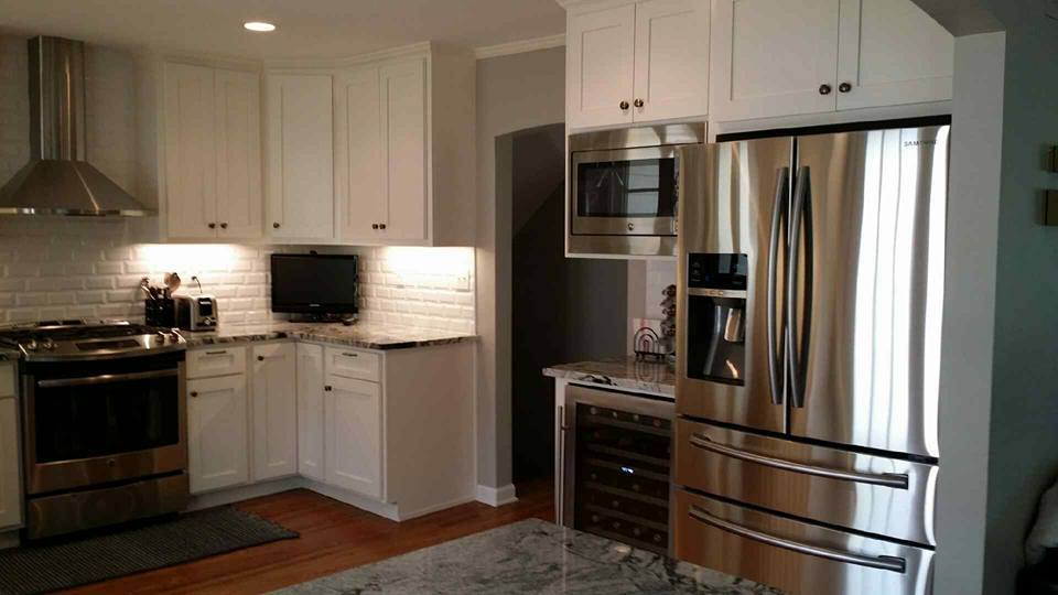 Kitchen island addition with granite countertop and custom cabinetry for holiday meal preparation