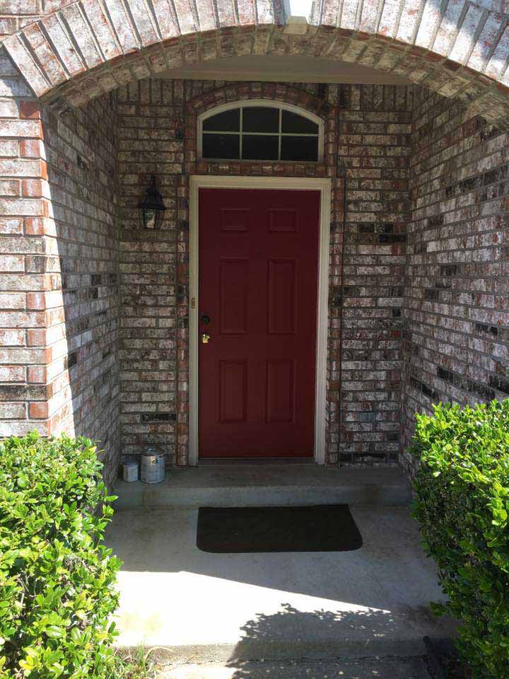 Elegant brick archway entrance with high-performance window installation showcasing quality craftsmanship