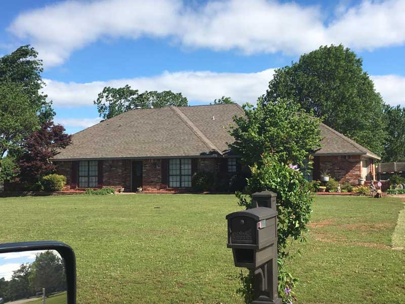 Well-maintained ranch-style home demonstrating proper roofing care and professional maintenance